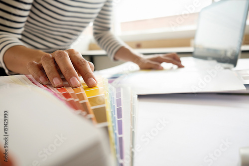 Graphic design and color swatches and pens on a desk. Architectural drawing with work tools and accessories. photo