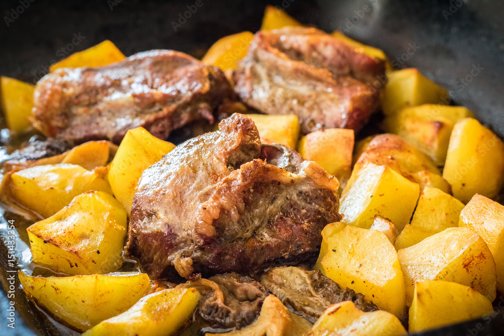 Shot of pork roasted with morel mushrooms and potatoes Shot of pork roasted with morel mushrooms and potatoes