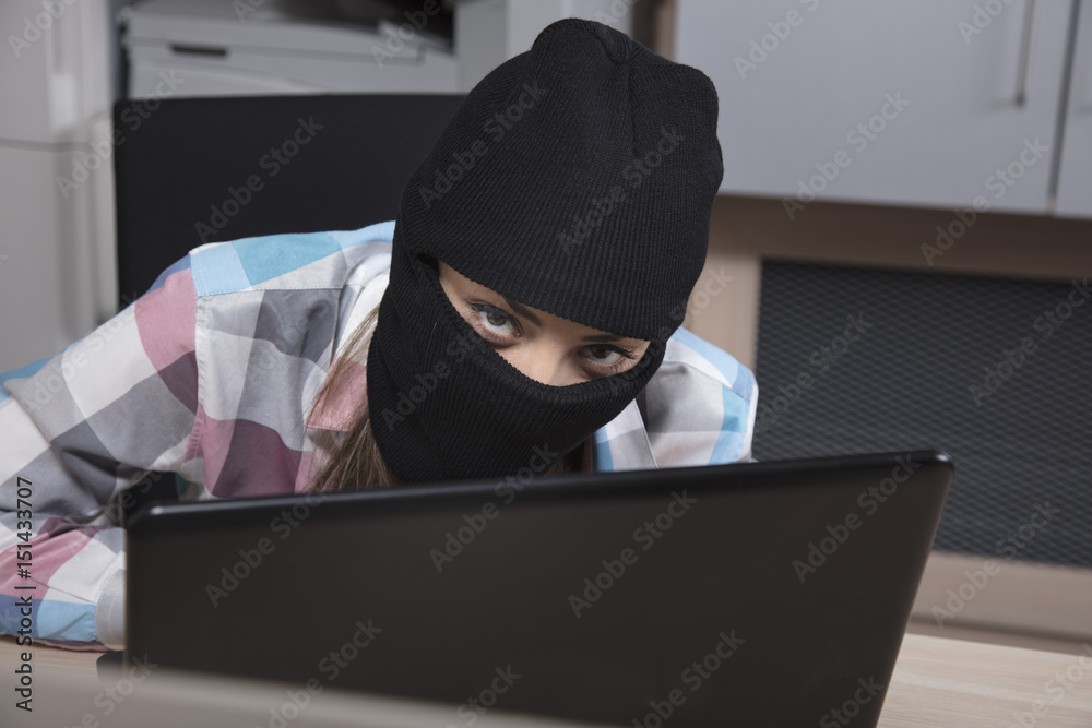 The hacker looks behind the monitor The hacker looks behind the monitor