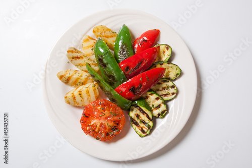 Grilled vegetables - zucchini potato and tomato. White background