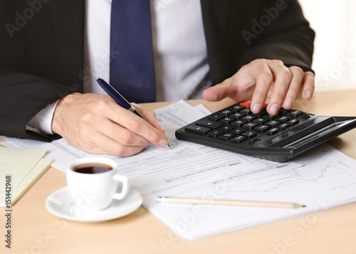 Man filling individual income tax return form, closeup
