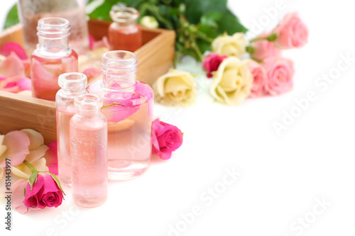 Beautiful composition with perfume bottles and roses on white background