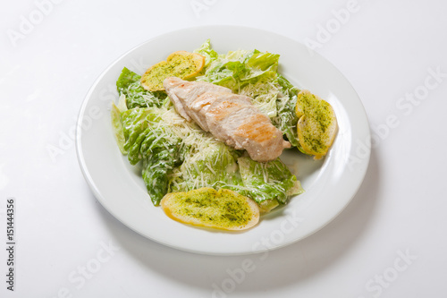 Caesar salad plate with cheese and garlic bread photo