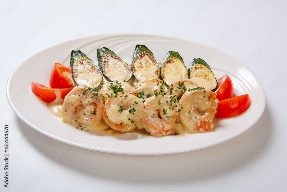 shrimps and grilled zucchini on a white plate shrimps and grilled zucchini on a white plate