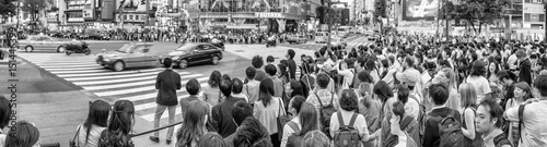 TOKYO - JUNE 1, 2016: Panoramic view of Shibuya Crossing with people at sunset. Shibuya is a popular district of Tokyo