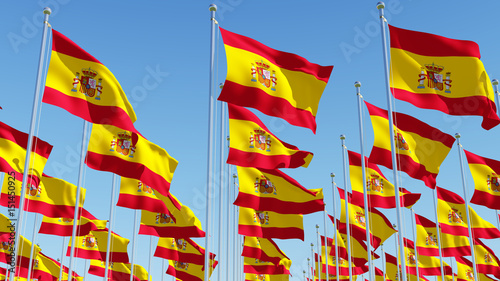 Many Flags of Spain against blue sky. Three dimensional rendering illustration.