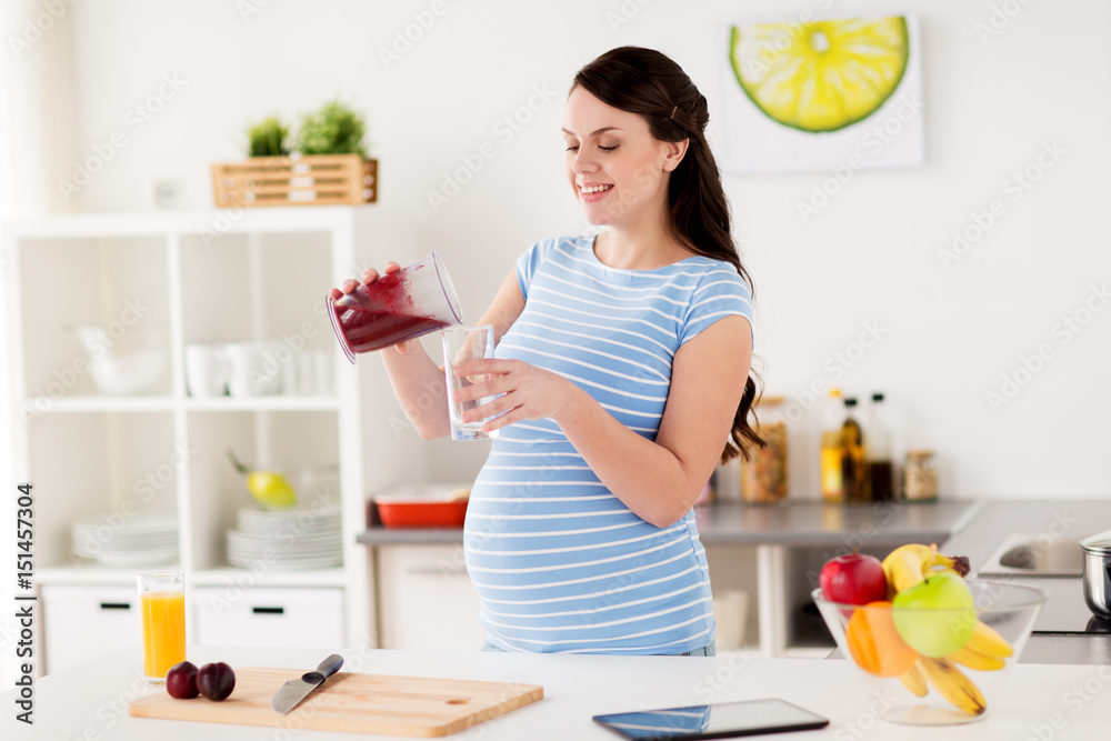 pregnant woman with blender cup and glass at home pregnant woman with blender cup and glass at home
