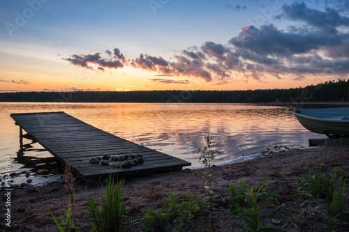 Landscape with idyllic beach and pier at summer evening © Jani Riekkinen
