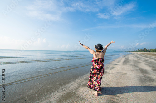 beautiful woman stand on the beach at sunny day and happy feel.