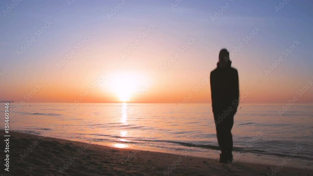 Young athletic man doing gymnastics on the sea early in the morning Young athletic man doing gymnastics on the sea early in the morning