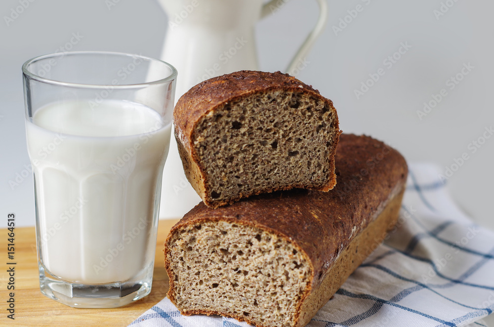 Homemade gluten free bread with linseed flour and psyllium husk. Glass of milk Homemade gluten free bread with linseed flour and psyllium husk. Glass of milk