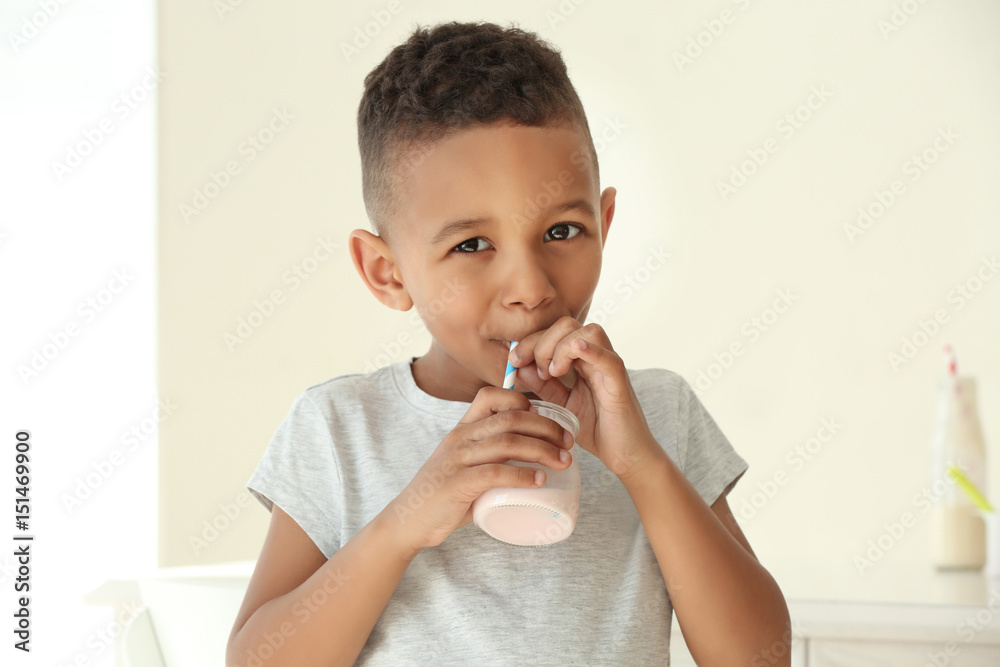 Cute African American boy drinking yogurt at home Stock Photo Adobe Stock