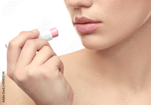 Beautiful young woman with lipstick on white background, closeup