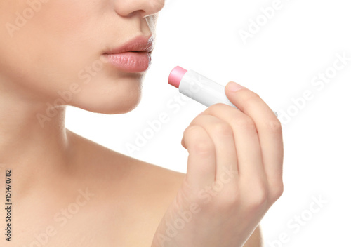 Beautiful young woman with lipstick on white background, closeup