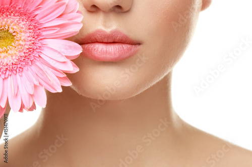 Beautiful young woman with flower on white background  closeup