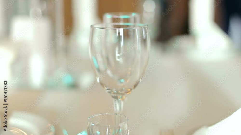 Empty wine glasses close-up illuminated by colored lights.