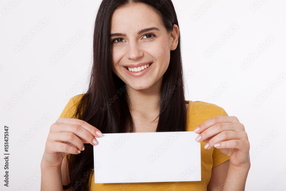Your text here. Pretty young woman holding empty blank board. Studio portrait on white background. Mock up for design Your text here. Pretty young woman holding empty blank board. Studio portrait on white background. Mock up for design