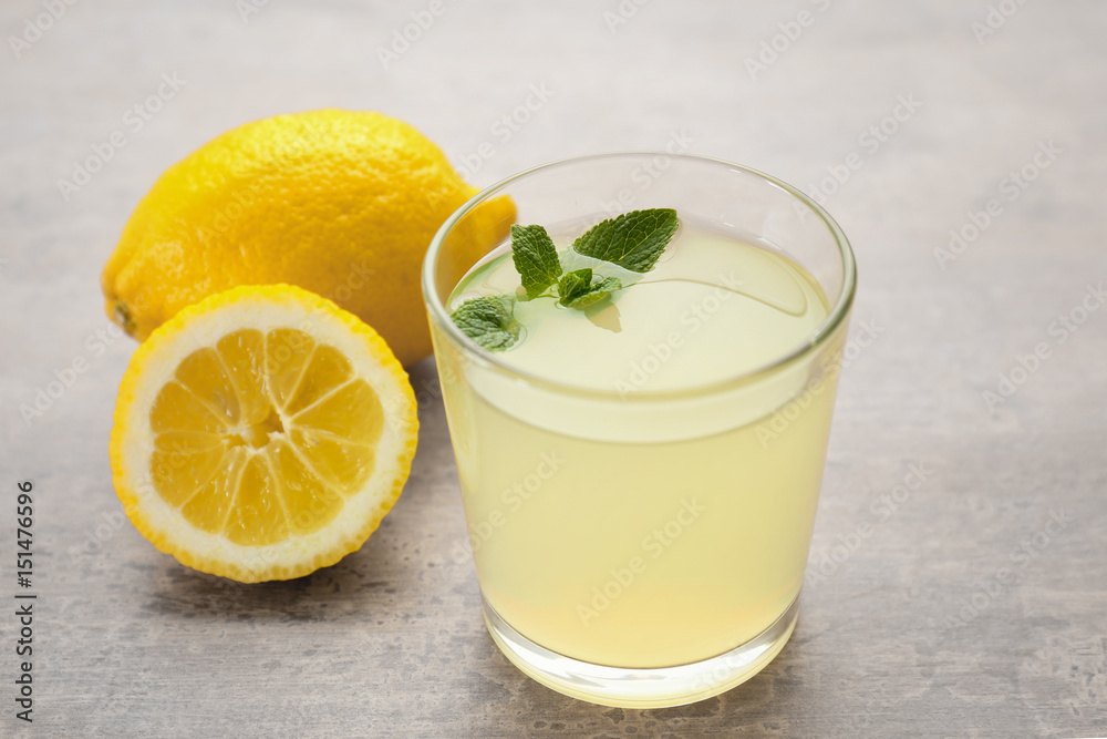 Glass of delicious lemon juice on table Glass of delicious lemon juice on table