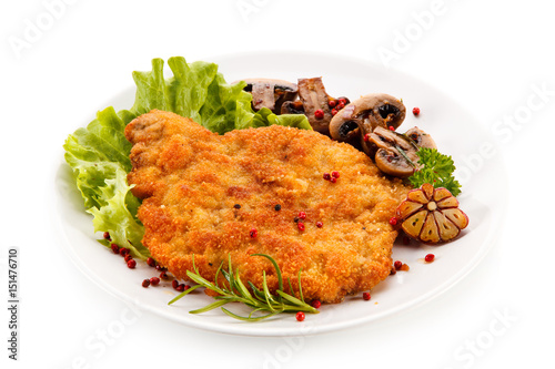 Fried pork chop with mushrooms on white background