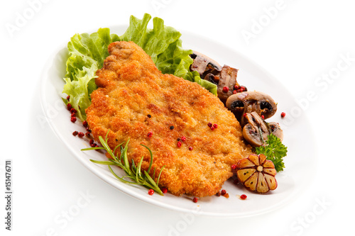 Fried pork chop with mushrooms on white background