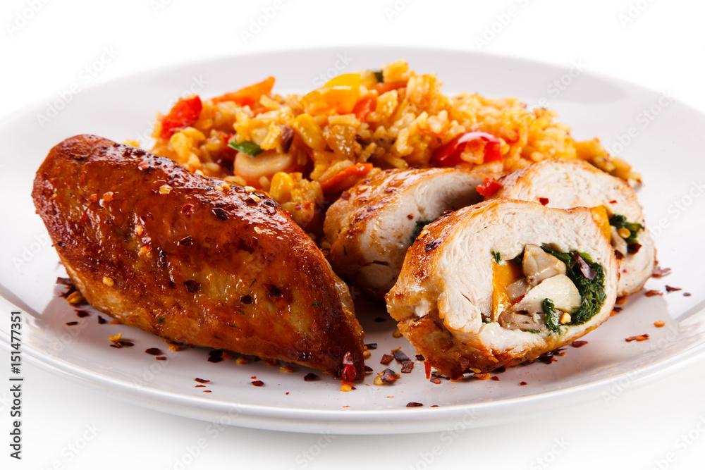 Stuffed chicken fillet with rice and vegetables on white background