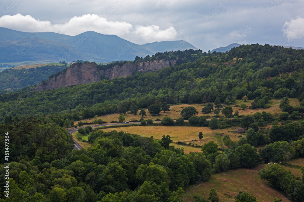 Panoramic view of mountain landscape and road through volcanic terrain at the volcanoes regional natural park in Auvergne, France