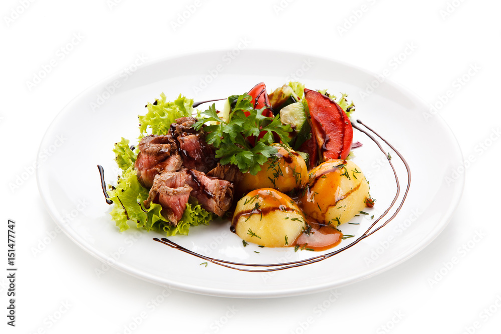 Carpaccio steaks with potatoes on white background
