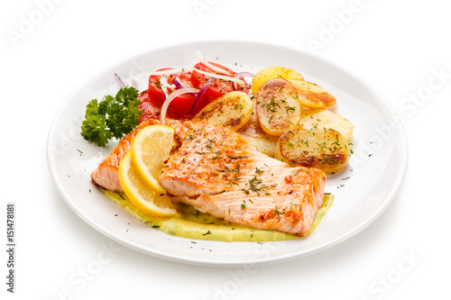 Grilled salmon with potatoes on white background