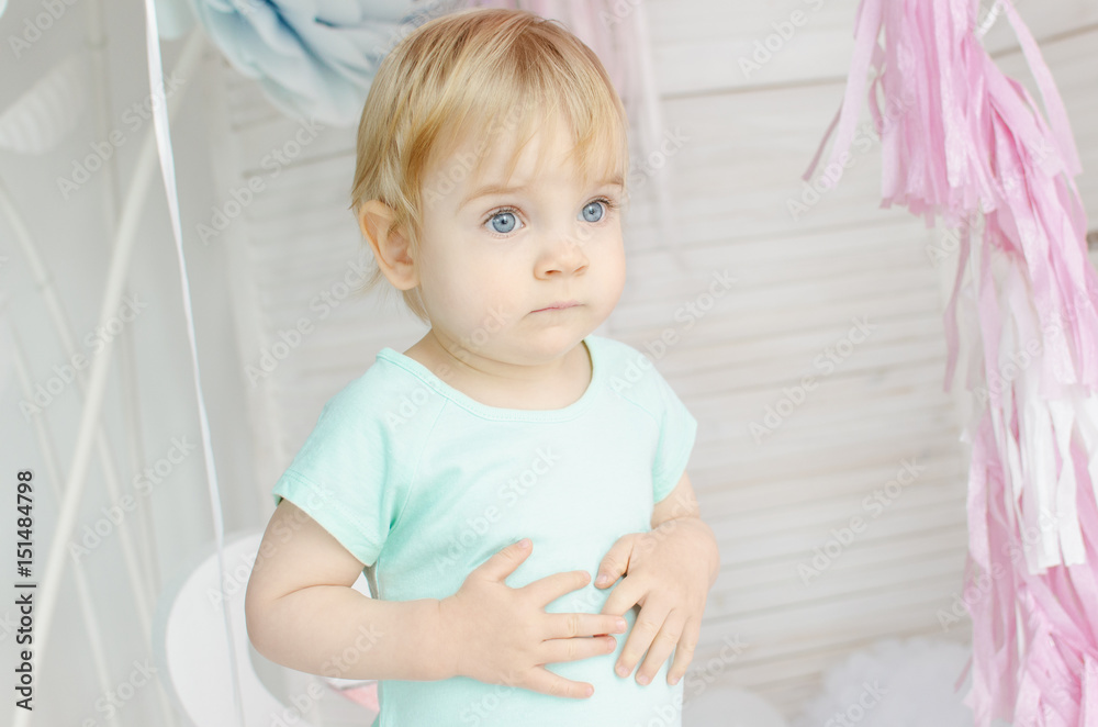 Little baby girl with beautiful eyes stands in the children's room Little baby girl with beautiful eyes stands in the children's room