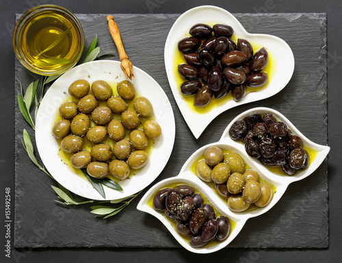 Three kinds of selected olives and olive oil.