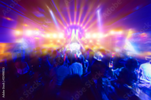 blur silhouettes of concert crowd in front of bright stage lights