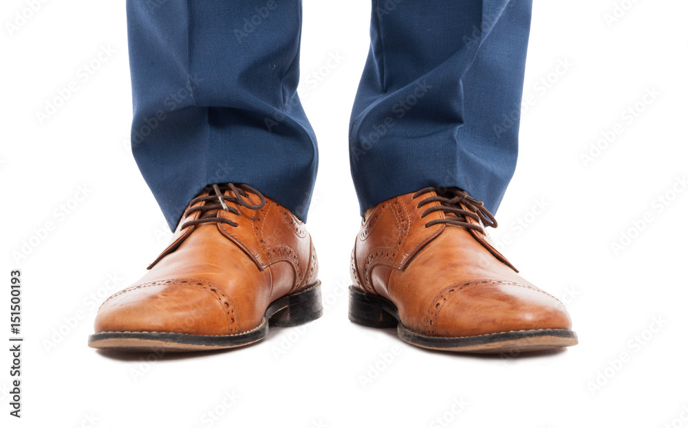 Feet of man with brown shoes in close-up