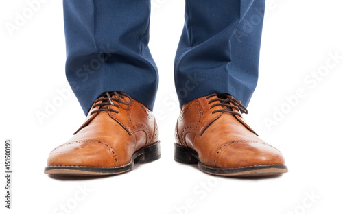 Feet of man with brown shoes in close-up