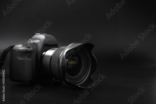  camera with lens on a black background. Canon is the world's largest SLR camera manufacturer. photo