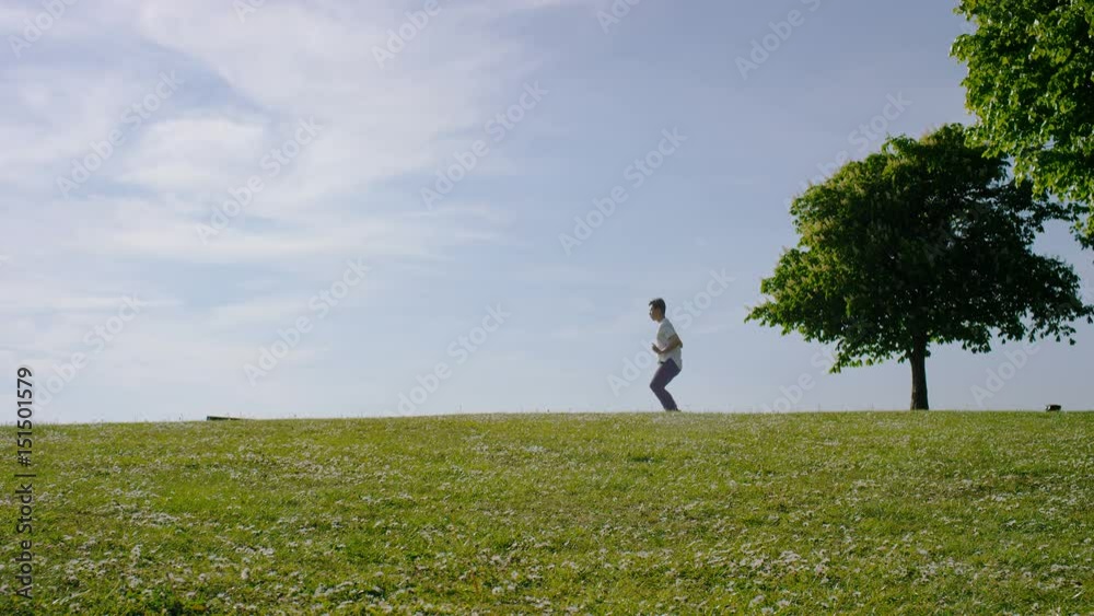 Lone man doing marital arts practice outdoors in the countryside Lone man doing marital arts practice outdoors in the countryside