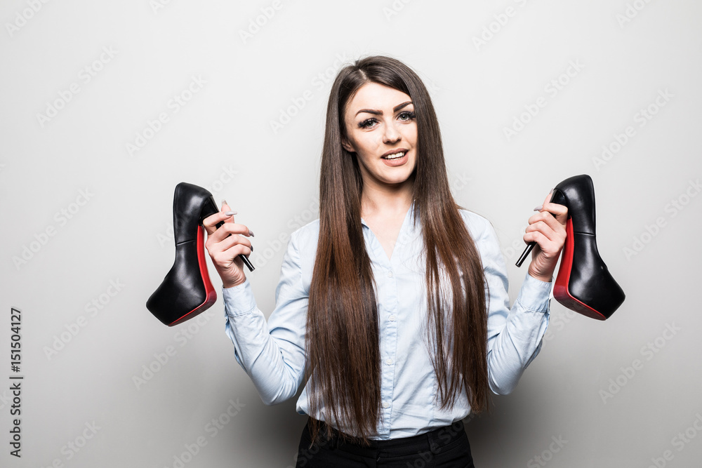 Portrait of a young beautiful girl with shoes in hands Portrait of a young beautiful girl with shoes in hands