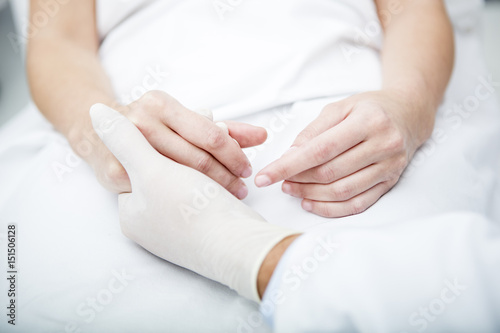 Doctor holding patient s hand