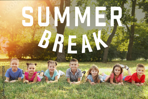 Happy kids lying on grass i...