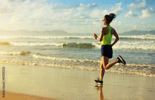 healthy lifestyle young fitness woman running on sunrise beach