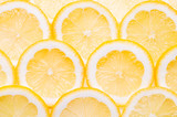 Lemon fruit slices background top view flat lay yellow background.