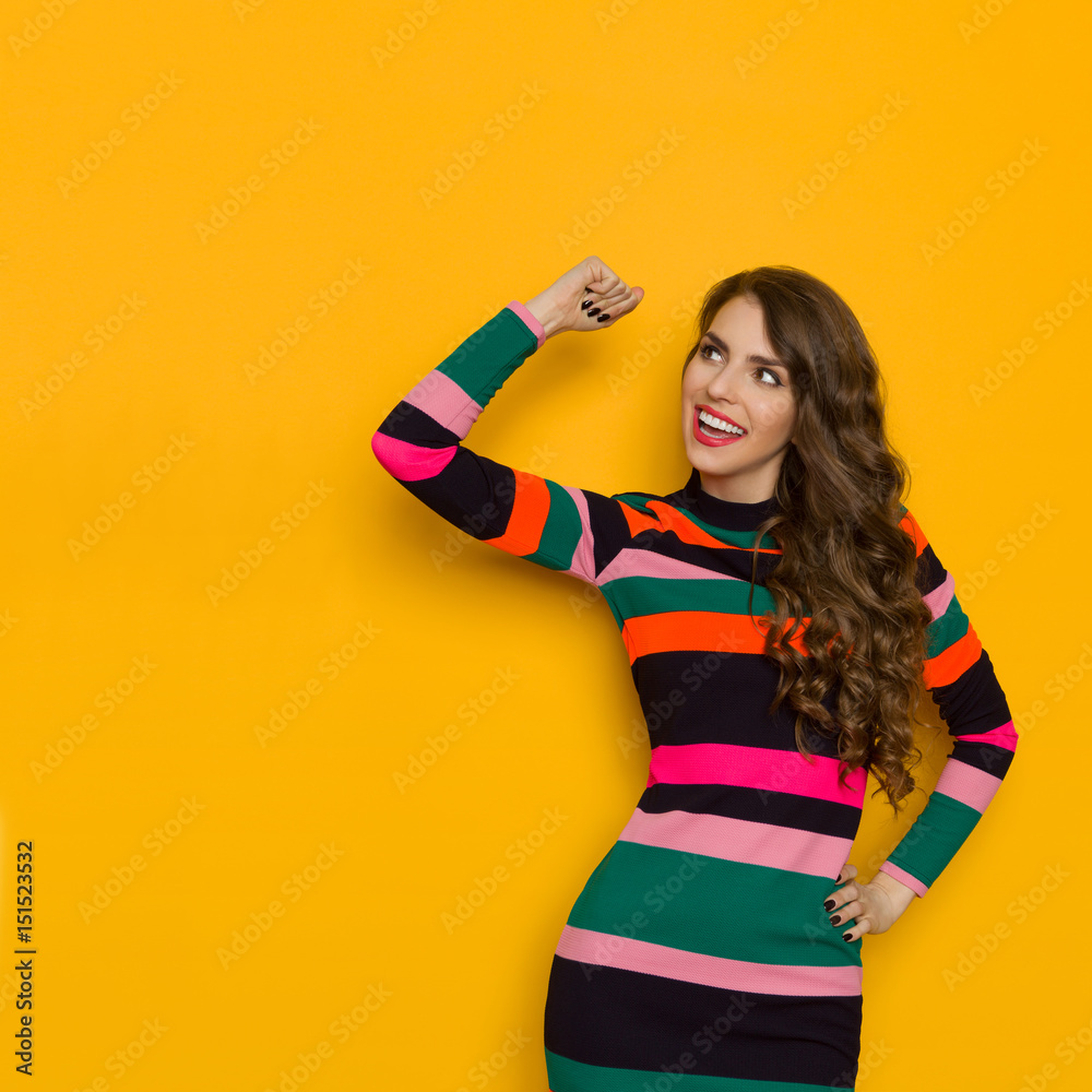 Vibrant Smiling Woman Is Flexing Arm And Looking Away Vibrant Smiling Woman Is Flexing Arm And Looking Away