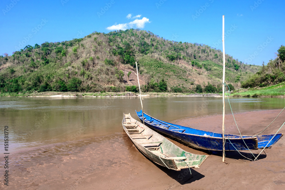 Two boats on the river bank.