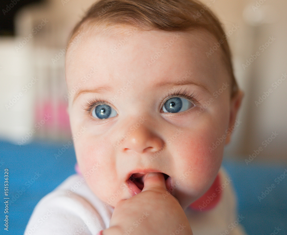 Teething concept. Baby girl with finger in mouth. Teething concept. Baby girl with finger in mouth.