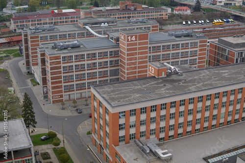 Typical rectangular industrial buildings made of red bricks and vertical windows in the old factory area in Zlin (Czech Republic)