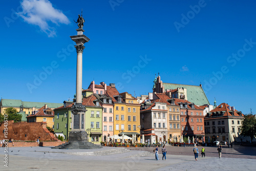 Unidentified people walk through Castle Square outside the Old Town of Warsaw, Poland
