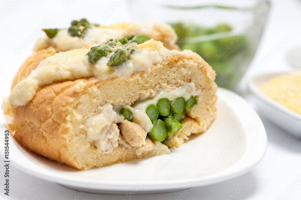Rolled sponge cake filled with chicken and asparagus