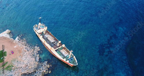  Beautiful seascape with old big, broken, rusty boat near the coast of Peyia, Cyprus. Ship graveyard. Famous landmark in the Mediterranean sea. © Kateryna