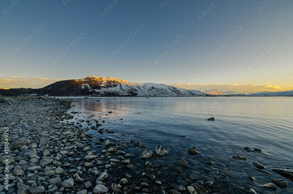 Beautiful morning at Lake Tekapo. Amazing view with the morning sun light shine on the snow capped mountain.