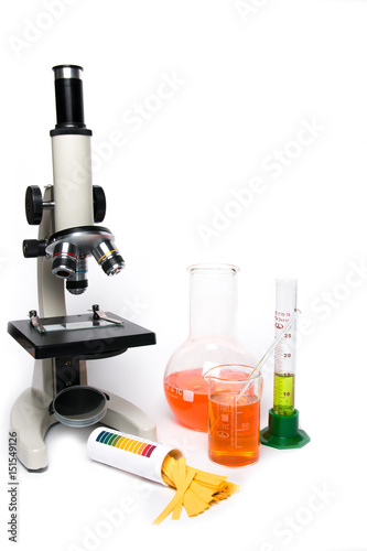 Microscope and laboratory glassware on a white background