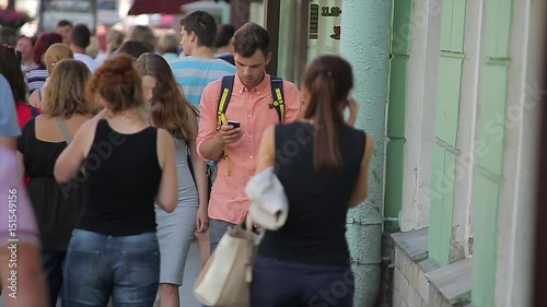 Young couple walking in the crowd at the city.
